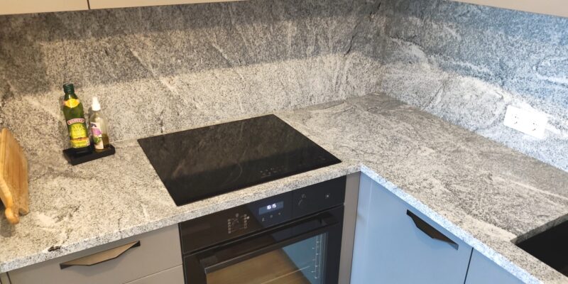 Gray but never boring – Viscount White granite in a traditionally stylish corner kitchen